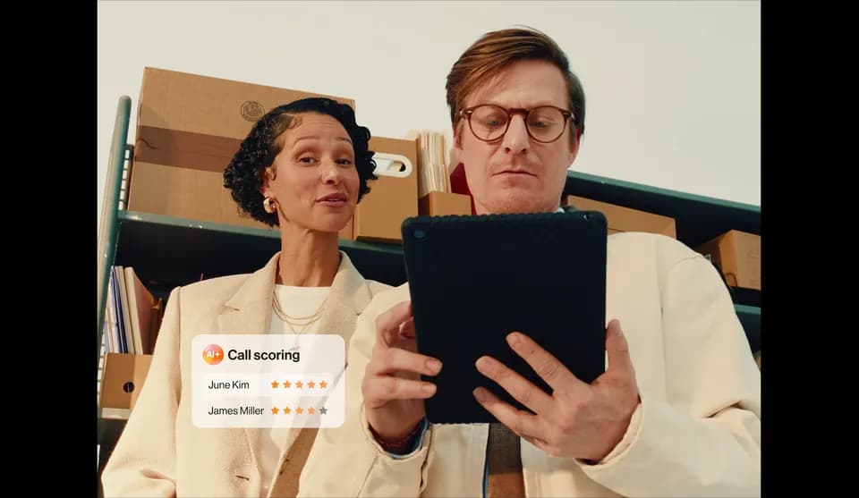 Man in round glasses holding a black tablet beside a woman, with a "Call scoring" overlay of star ratings