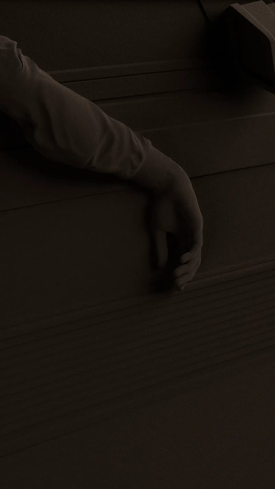 Forum brand identity: dark brown bas relief scene of a slender arm resting across layered, ribbed surfaces in low light