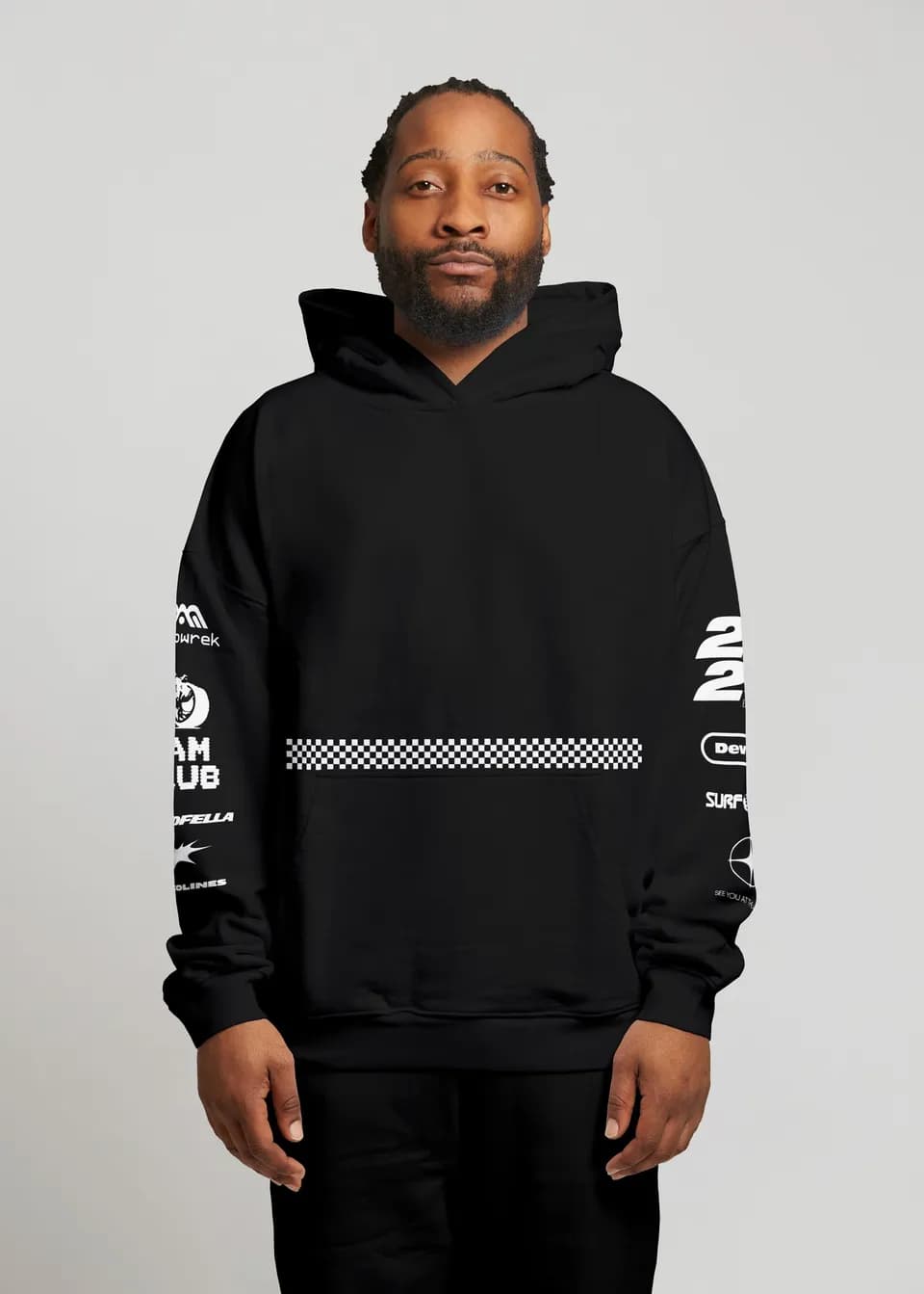 Santa Monica House Mafia hoodie: black oversized hoodie on a man, checkerboard stripe at the waist, logos down both sleeves