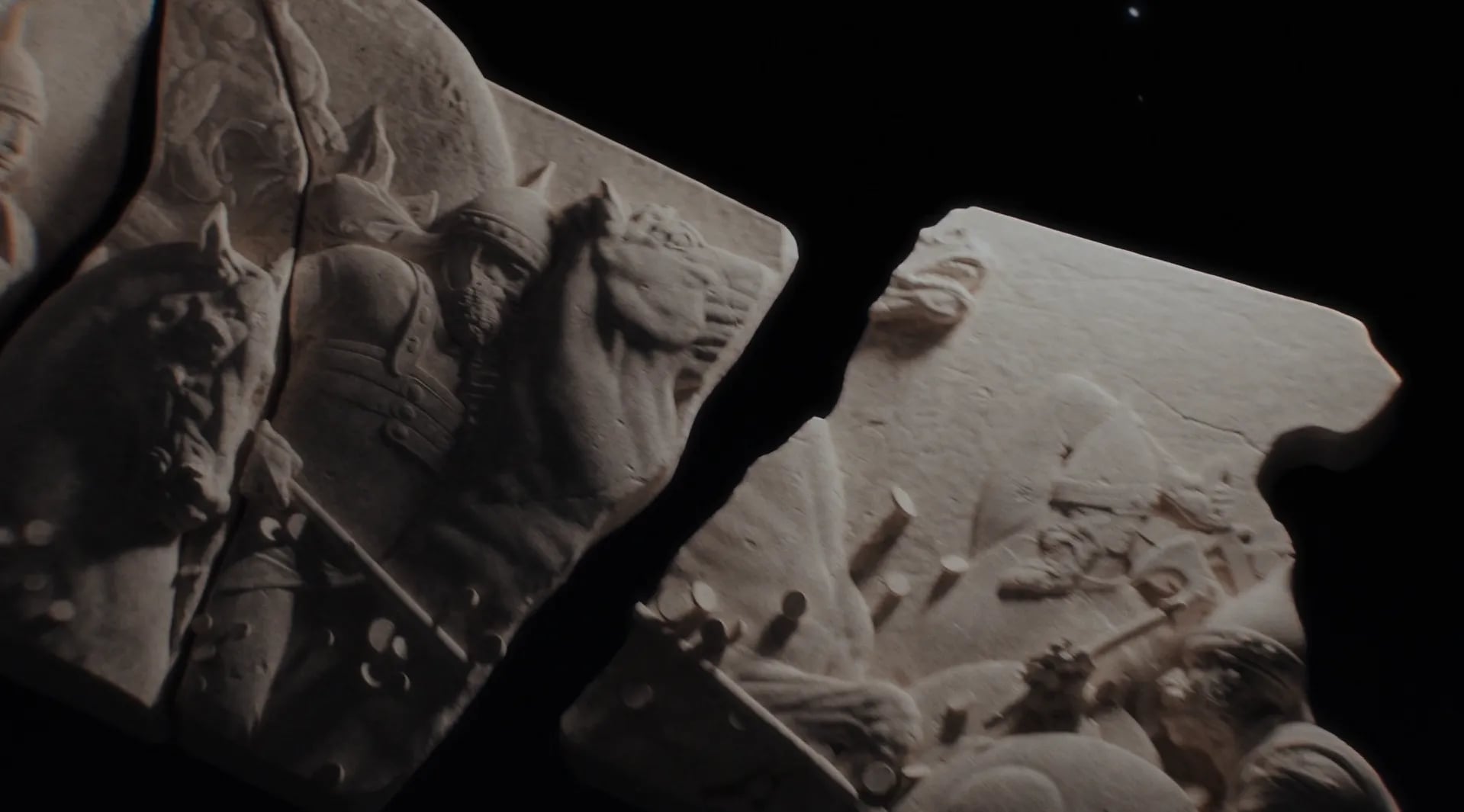 Broken stone relief fragments showing an armoured rider on a horse, separated by a black gap, in the Forum brand video