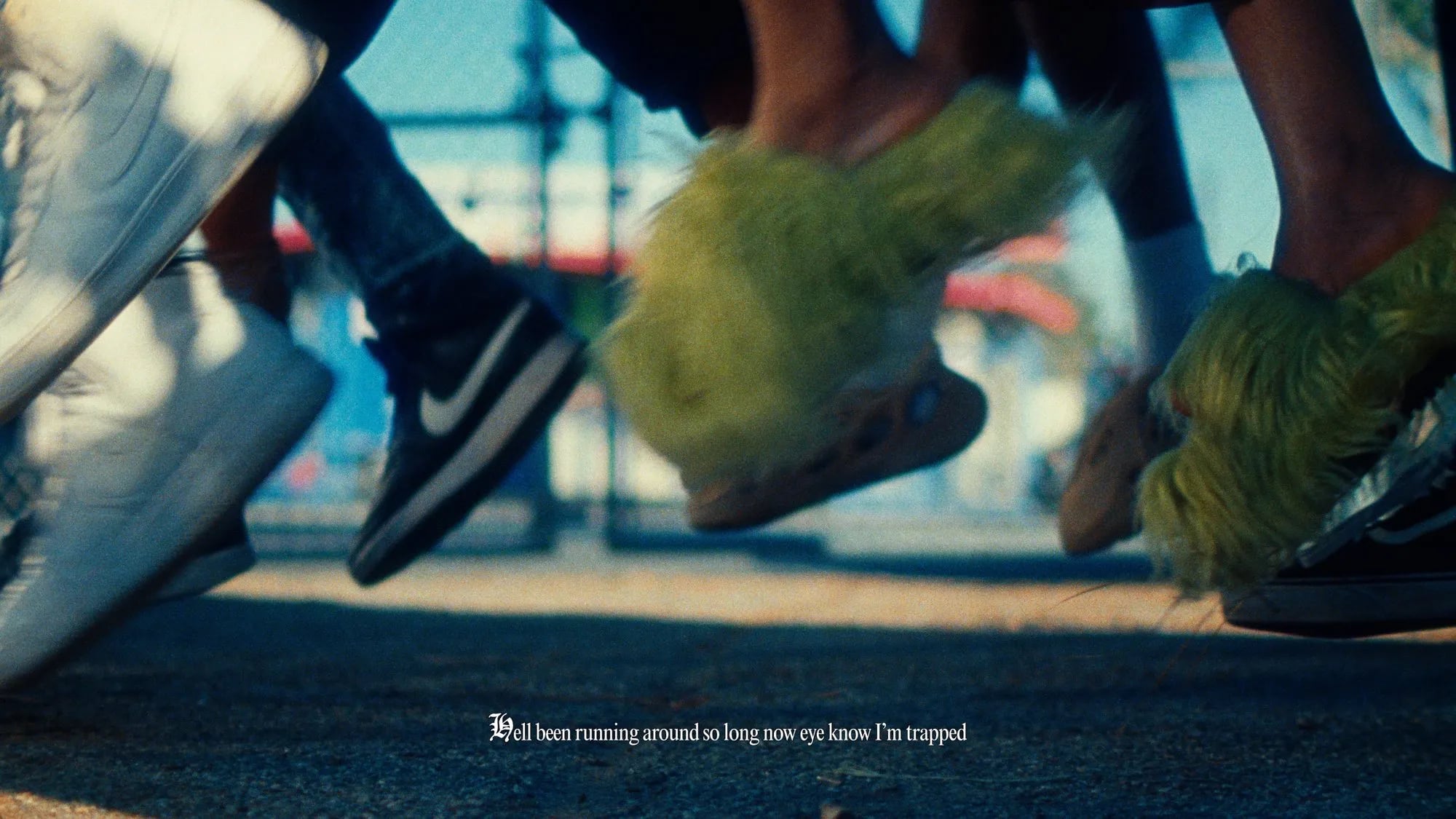 Low frame of feet running on pavement, one pair in fuzzy green slippers, subtitle "Hell been running around so long"